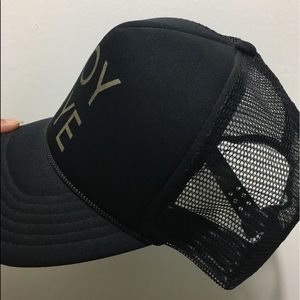 Black “BOY BYE” hat. Gold lettering.